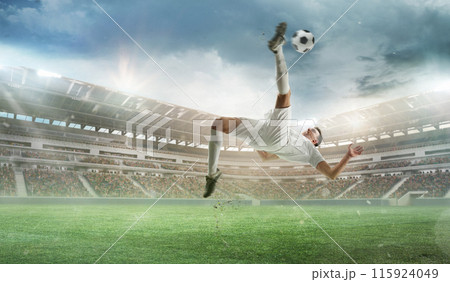 Dynamic image of competitive man in white uniform, soccer player during intense match, hitting ball with leg and falling down. 3D render of open air stadium Dynamic image of competitive man in white uniform, soccer player during intense match, hitting ball with leg and falling down. 3D render of open air stadium 115924049