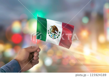 Generative AI Image of Hand Holding a Mexican Flag in Mexico Independence Day on Blur Background 115924189