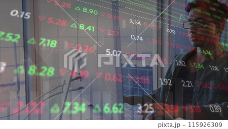Image of graph and trading board over tired biracial man working over laptop in office 115926309