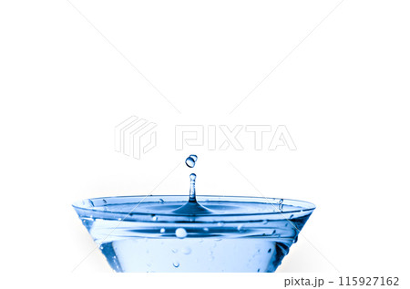 Close-up of water drop falling into a glass on white background 115927162