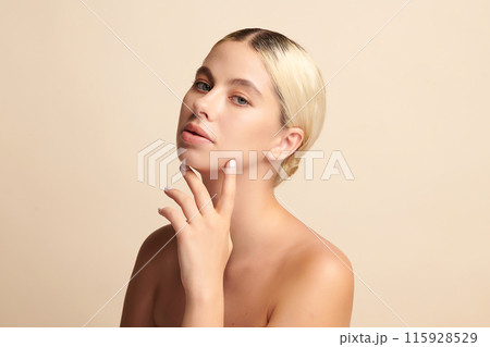 Beautiful young woman with clean fresh skin on beige background, Face care, Facial treatment, Cosmetology, beauty and spa, women portrait. Beautiful young woman with clean fresh skin on beige background, Face care, Facial treatment, Cosmetology, beauty and spa, women portrait. 115928529