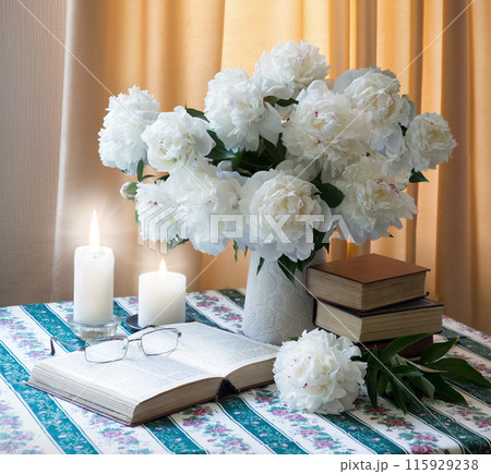 Book near a bouquet of flowers 115929238