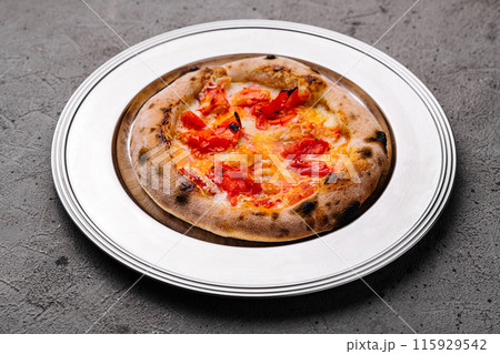 Freshly baked margherita pizza on plate 115929542
