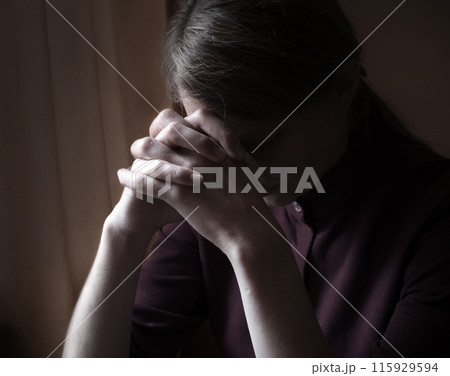 Praying woman at the window Praying woman at the window 115929594
