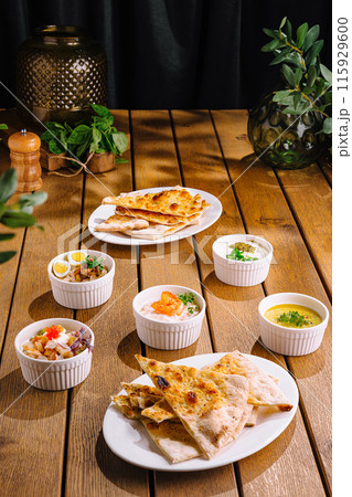 Gourmet mediterranean feast on rustic wooden table 115929600