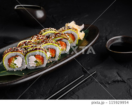 Elegant sushi platter on dark background Elegant sushi platter on dark background 115929954