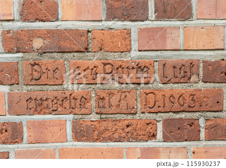 Part of brick wall. Inscription in German Dieses Portal ist eingebaut A.D. 1903 on wall of the Kaliningrad Cathedral. This portal is built A.D. 1903 115930237