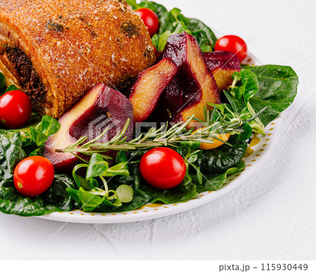 Delectable roasted pork dish with fresh vegetables 115930449