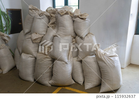 A pile of white sacks stacked on top of each other 115932637