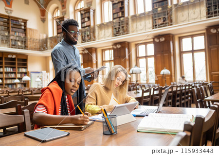 Group of international students working together in the library 115933448