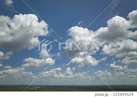 White puffy cumulus clouds on summer blue sky White puffy cumulus clouds on summer blue sky 115934524