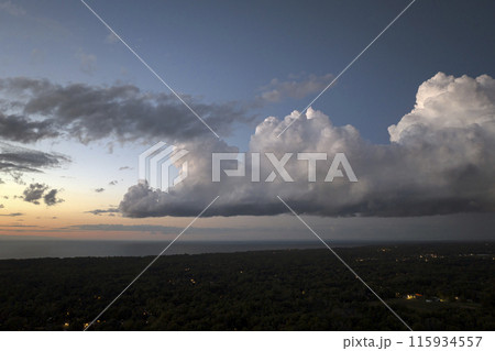 Evening sunset sky with colorful clouds over dark land. Panoramic skyscape Evening sunset sky with colorful clouds over dark land. Panoramic skyscape 115934557