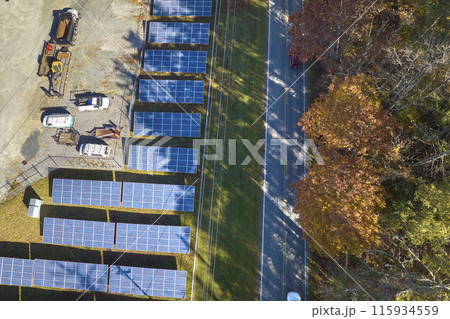 Aerial view of large sustainable electrical power plant with rows of solar photovoltaic panels for producing clean electric energy. Concept of renewable electricity with zero emission 115934559