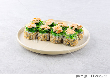 Chuka Roll. Sushi composition on black background. The Art of Japanese Cuisine. Food photography for menu and sushi bar decoration Chuka Roll. Sushi composition on black background. The Art of Japanese Cuisine. Food photography for menu and sushi bar decoration 115935236