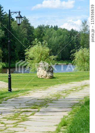 Landscape with stone path, lantern and pond in a park on a summer afternoon. 115936639