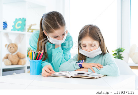 Home schooling of cute sisters during pandemic Home schooling of cute sisters during pandemic 115937115