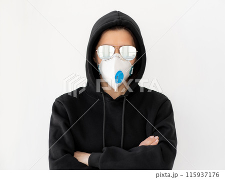 Woman in black jacket with glasses and face mask 115937176