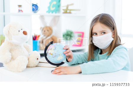Nice school girl viewing globe at home during quarantine Nice school girl viewing globe at home during quarantine 115937733