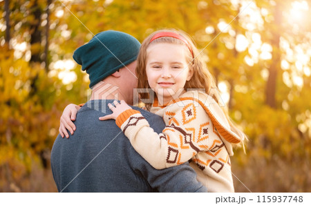 Father hugs with daughter on blurred autumn background 115937748