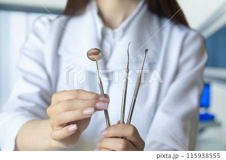 Dentist shows tools used in dental treatment. Dentist shows tools used in dental treatment. 115938555
