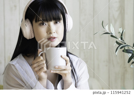 ヘッドホンで音楽を聴く若い女性 115941252
