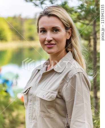 Smiling woman enjoying nature with trees and lake background Smiling woman enjoying nature with trees and lake background 115941335