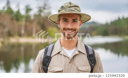 Happy hiker enjoying nature near serene lake 115942320