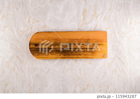 Wooden cutting board on a gray marble background 115943287