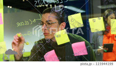 Image of connected dots forming abstract shape over caucasian woman writing on glass wall 115944199