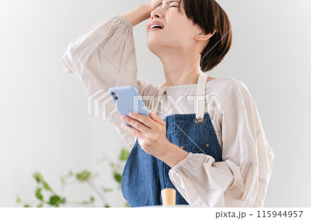 エプロン姿で料理する若い女性 ライフスタイルイメージ エプロン姿で料理する若い女性 ライフスタイルイメージ 115944957