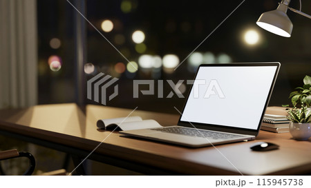 A laptop computer mockup on wooden table against the window with city nightlight view. A laptop computer mockup on wooden table against the window with city nightlight view. 115945738
