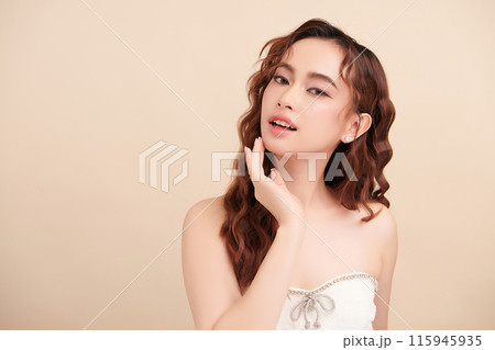 Beautiful young asian woman with clean fresh skin on beige background, Face care, Facial treatment, Cosmetology, beauty and spa, Asian women portrait. Beautiful young asian woman with clean fresh skin on beige background, Face care, Facial treatment, Cosmetology, beauty and spa, Asian women portrait. 115945935