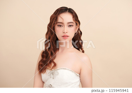 Beautiful young asian woman with clean fresh skin on beige background, Face care, Facial treatment, Cosmetology, beauty and spa, Asian women portrait. Beautiful young asian woman with clean fresh skin on beige background, Face care, Facial treatment, Cosmetology, beauty and spa, Asian women portrait. 115945941