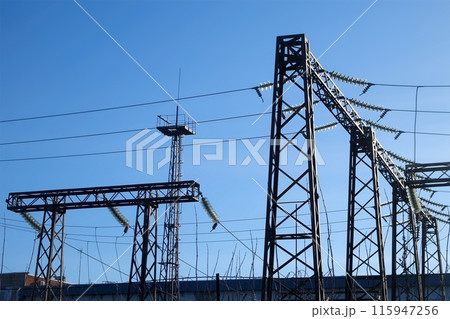 High voltage electric plant with towers equipment producing electricity in city. High voltage electric plant with towers equipment producing electricity in city. 115947256
