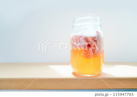 白背景にガス抜きでぶくぶくと泡が出ている苺の手作り天然フルーツ酵母 115947783