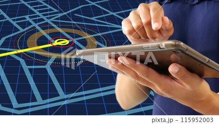 Mid section of a woman using a digital tablet against navigation map line scheme on blue background 115952003