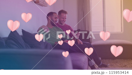Image of heart icons over happy diverse gay couple embracing 115953414