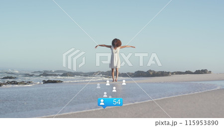 Image of stars over african american woman raising hands at beach Image of stars over african american woman raising hands at beach 115953890
