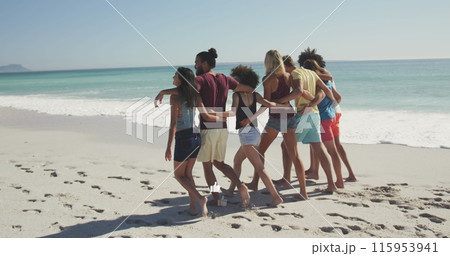 Image of american flag over diverse group of friends at beach 115953941