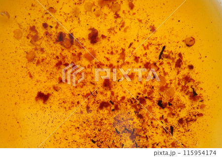 Used vegetable oil in a plate . 115954174