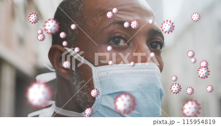 A black man walking around in the city, wearing a face mask to protect himself from air pollution an 115954819
