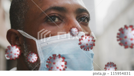 Image of covid 19 cells over african american man wearing face mask 115954831