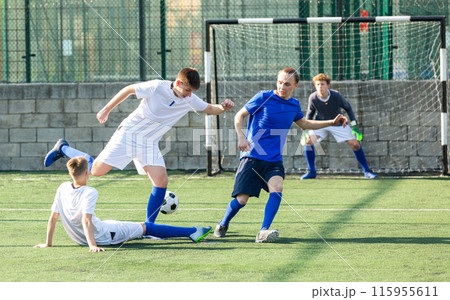Junior football teams having scrimmage 115955611