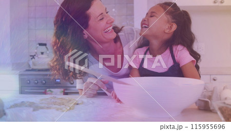 Image of lights over happy caucasisan mother and daughter cooking together Image of lights over happy caucasisan mother and daughter cooking together 115955696