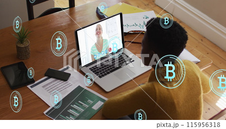 Image of bitcoins over african american woman having image call on laptop 115956318