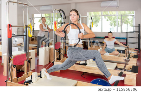 Young woman exercising with pilates ring Young woman exercising with pilates ring 115956506