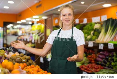 Pretty young saleswoman posing at grocery 115957406