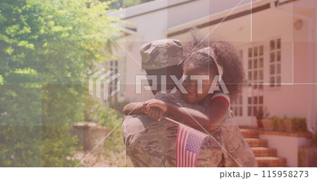 African American young adult hugging biracial student outside house 115958273