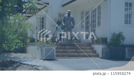 African American youth and biracial child walk down steps holding hands African American youth and biracial child walk down steps holding hands 115958274