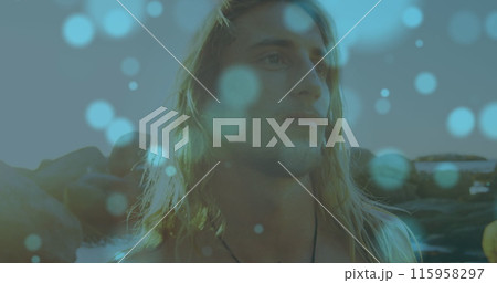 Caucasian young adult male with long blonde hair is looking thoughtful 115958297